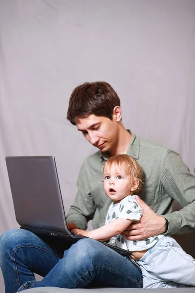 Handsome Young Man Working Home Laptop Baby His Hands Stay — Stock Photo, Image