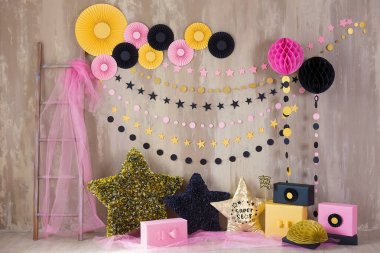 Studio shoot with decor inspired by designers and florist soul with colorful paper flowers on wall and black golden star pillows. Super star pillow deisined by photographer clipart