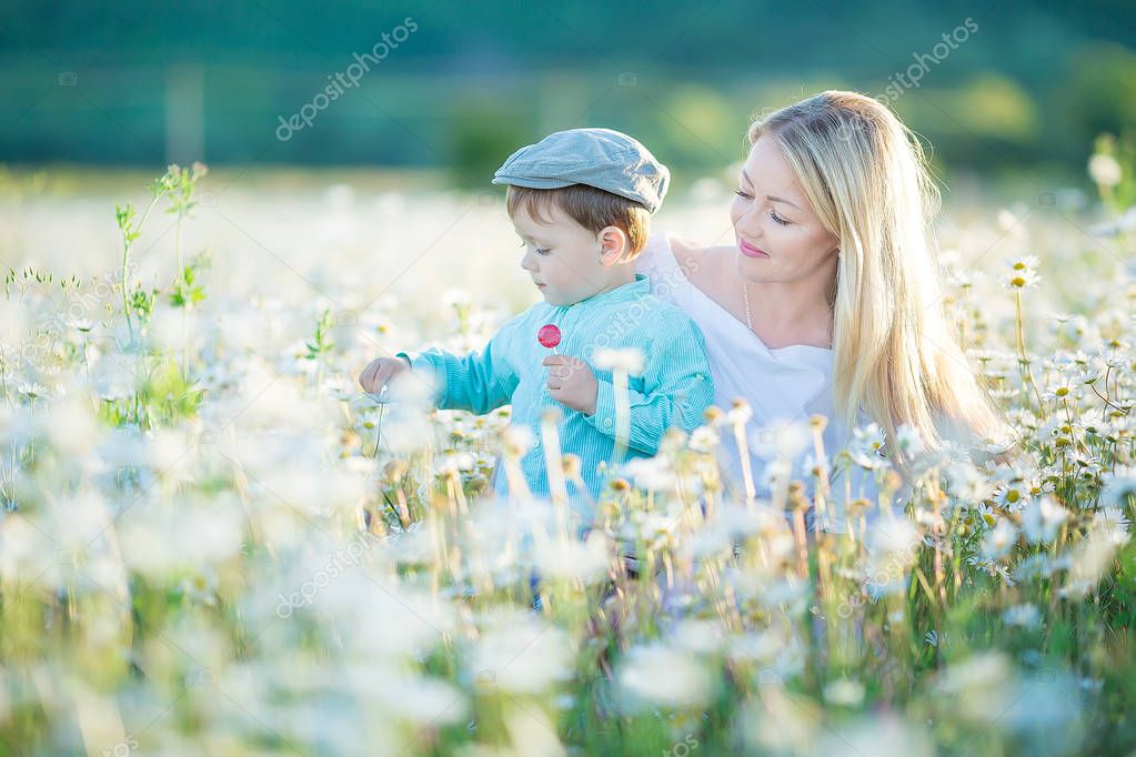 Joyful woman walk on green yellow flowering field background, rest, have fun, play, toss up little cute child baby boy. Mother, little kid son. Family day 15 of may, love, parents, children concept.