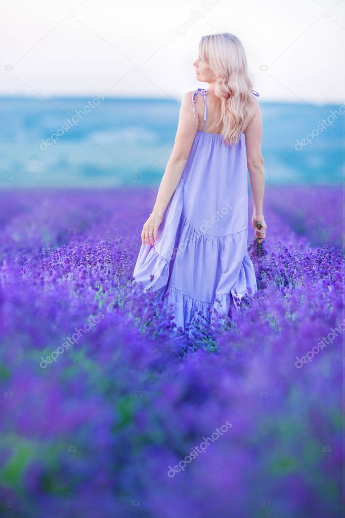 Beautiful girl lady on the lavender field enjoy life with relax and flowers spa.woman freedom power.