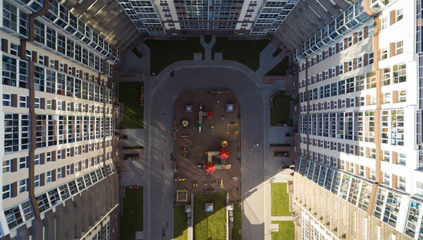 Bird-eye view of the playground kids in a residential complex in sunny day