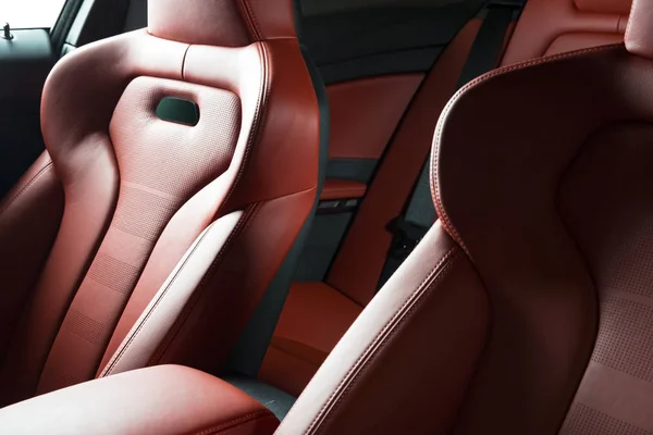 back seats of modern luxury car, red leather interior