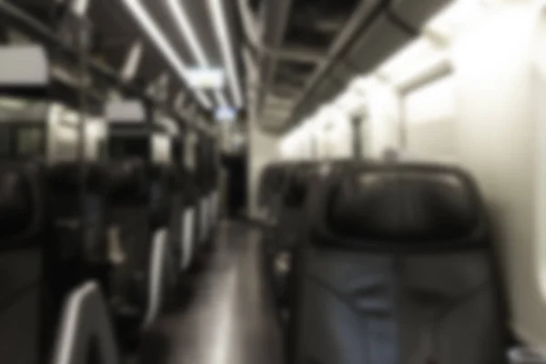 Interior inside first class cabin modern train. Nobody, leather comfortable seats and table. Business Travel.  Abstract blurred background
