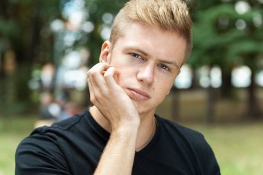 Parkta diş ağrısı çeken bir adamın portresi.