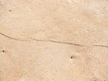 Sahildeki kum zeminini kapatın, arka planda ve desenli