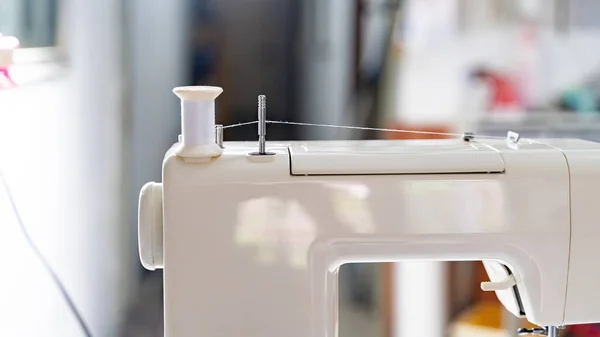 Electric sewing machine with fabric and thread
