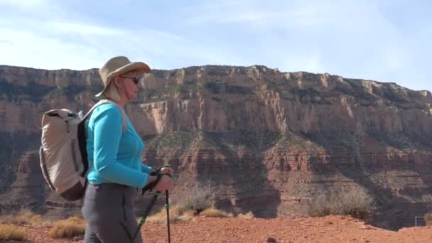 Fat Mature Woman With Trekking Poles And A Backpack Hiking In The Grand Canyon