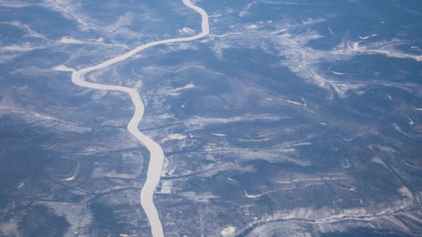 Вид з вікна літака на зимових землі з Обледенілі річки — стокове відео