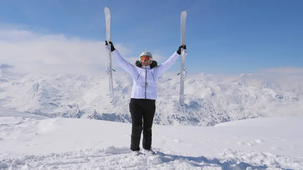 Yokuş aşağı onun kayaklar dağın üzerinde mutlu kadın yükseltir