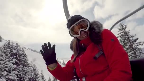 Woman Skier Climbs On The Chair Lift To The Top Of The Mountain Shows Thumb Up — Stock Video