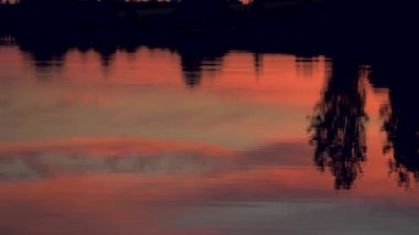 Panorama adlı göle yansıyan gökyüzü ile romantik kırmızı günbatımı bakış