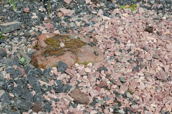 A scattering of red and gray granite crushed stone