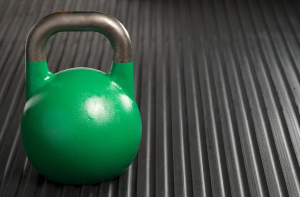 Kettlebell de levantamiento de pesas verde de 24 kg dentro de un gimnasio — Foto de Stock