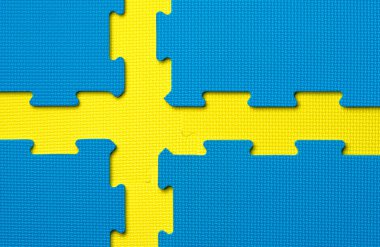 Yellow and blue gym floor tiles in the shape of the Swedish flag clipart