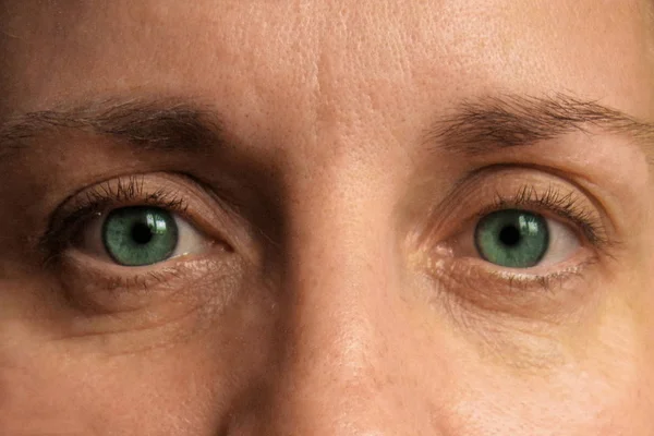 Orta yaşlı kadın gözlerinin yakın çekim. Makyaj olmadan gerçek yüz ve