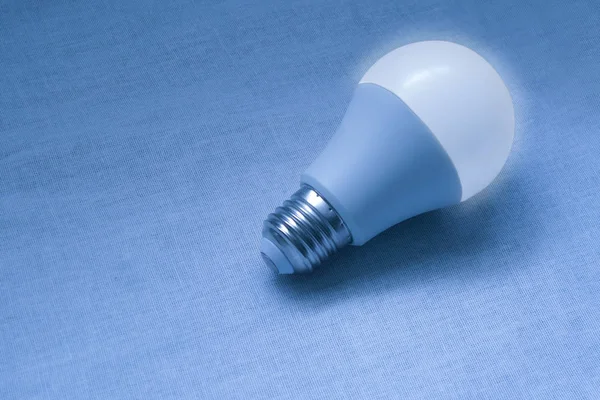 LED bulb lamp closeup image. Blue concept poster of electricity