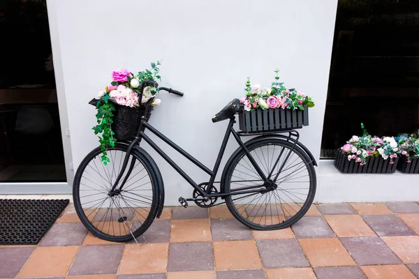 Retro bicycle as a flowerbed decoration outside element. Black a — Stock Photo, Image