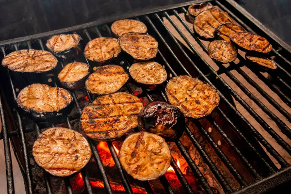 Eggplants grill. Vegetables are fried or baked on open fire. Bar