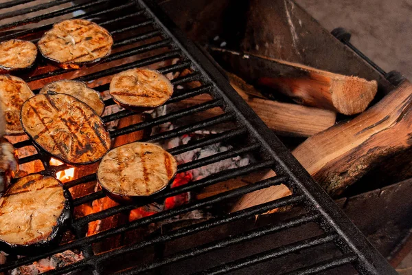 Eggplants grill. Vegetables are fried or baked on open fire. Bar