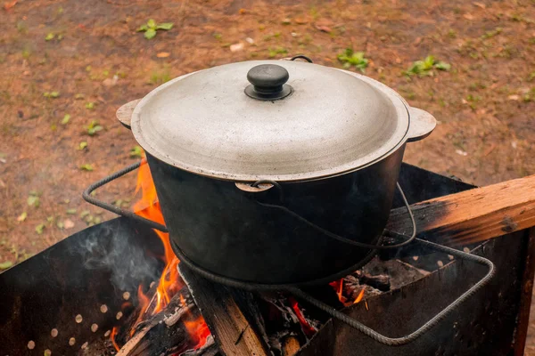 Open air kitchen at party picnic. Pilaf cooking on fire outdoor. — Stock Photo, Image