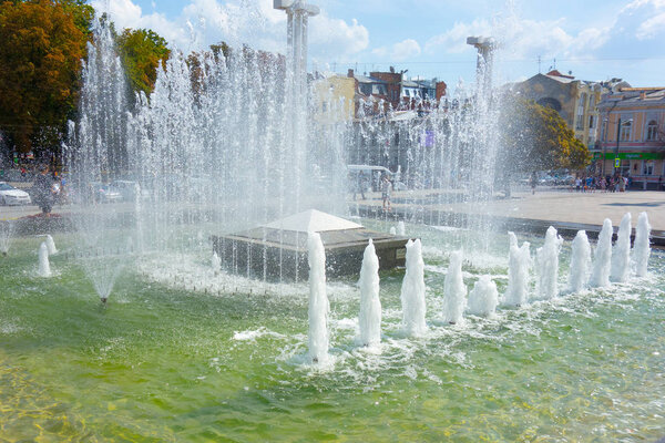 Waterworks fountain with water sprays and geysers on city park o