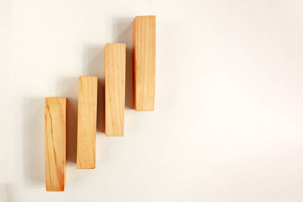 Wood bar pieces with shadows on white background. Climbing verti