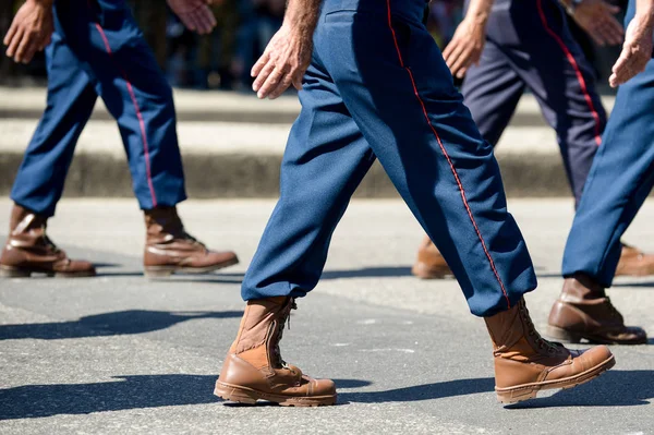 Military marching in a street. Legs and shoes in line.