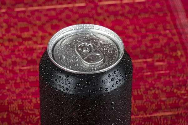 black aluminum can, with drops of water.