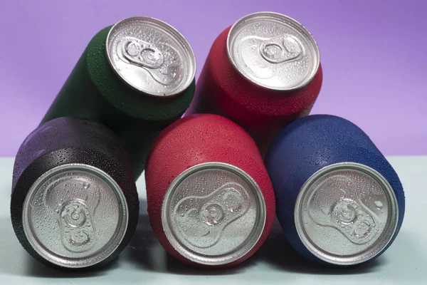 Colorful aluminium cans with a carbonated drink.