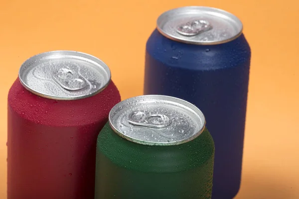 Colorful aluminium cans with a carbonated drink.
