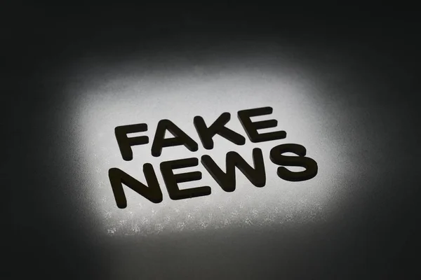 Wort Fake News Holzbuchstaben Geschrieben Und Durch Hintergrund Gegenlicht Beleuchtet — Stockfoto