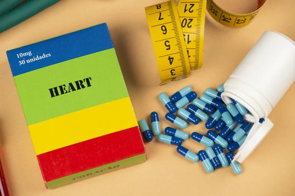 Fake medicine box with the name of the disease Heart and a glucometer.