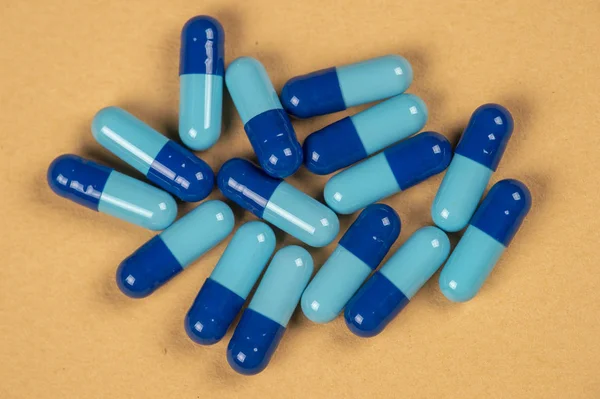 Pill capsules and two shades of blue — Stock Photo, Image