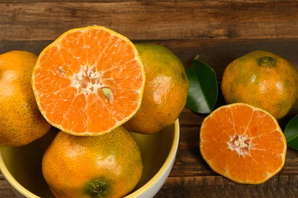 Fresh mandarin oranges fruit or tangerines in wooden table