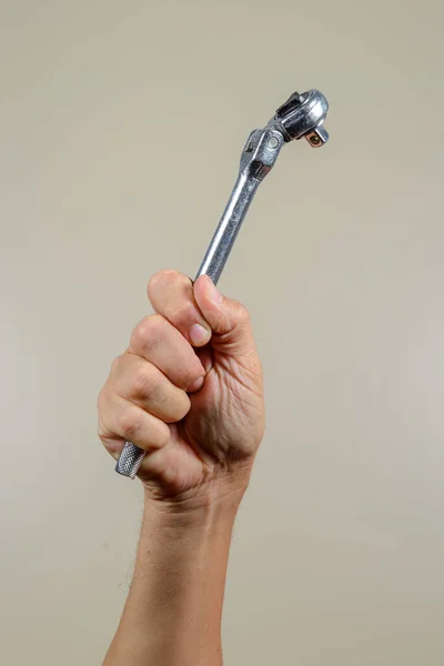 industry worker hand holding mechanical tool