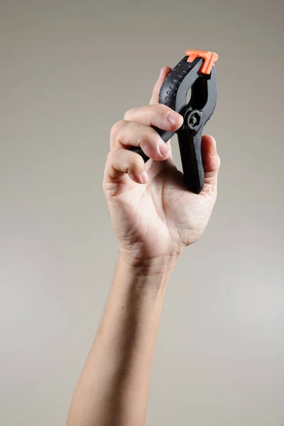 industry worker hand holding mechanical tool