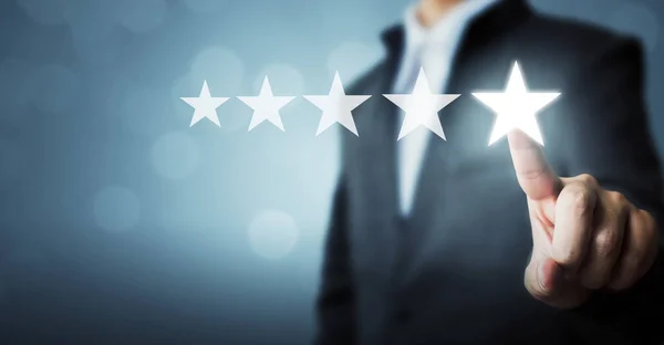 Businessman pointing five star symbol to increase rating of company — Stock Photo, Image