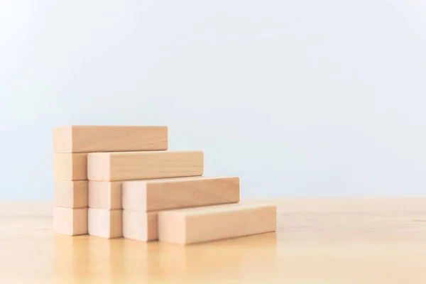 Wood block arranging stacking as step stair. Ladder career path concept for business growth success process