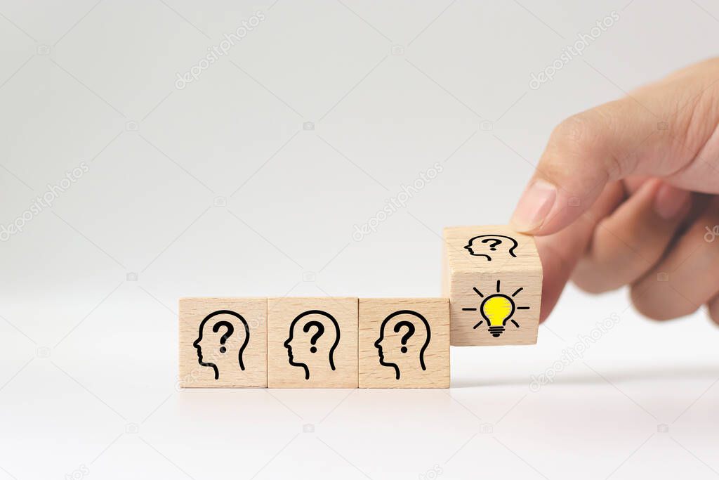 Hand flip over wooden cube block with head human symbol and light bulb icon. Concept creative idea and innovation