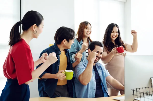 Excited group business people feeling euphoric celebrating online win success achievement result, young man and woman happy about good email news, motivated by great offer or new opportunity