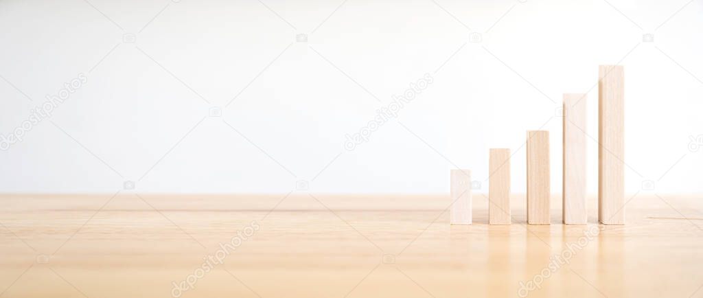 Wooden block as graph step up staircase on wood desk. Ladder career path concept for business growth success process. Panoramic image
