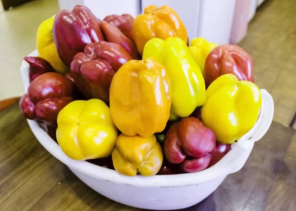 pictured in the photo Red and yellow sweet bell peppers on table, close up