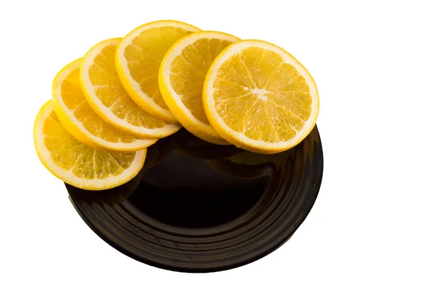 Orange slices on a black plate on white backgrond — Stock Photo, Image