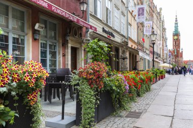 Gdansk, Polonya - 5 Haziran 2018: Görünüm uzun Çarşı Caddesi ve Belediye Binası. Sokak restoranlarda çiçek süslemeleri