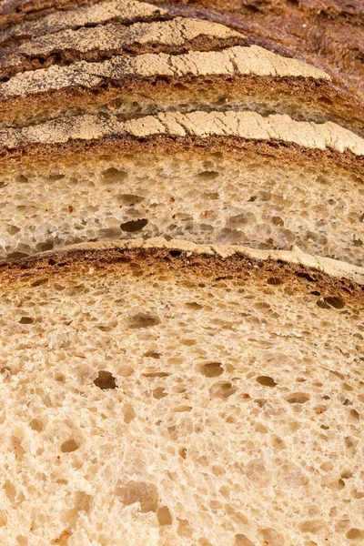 Background of slices of rye wheat bread, bread crust, close up