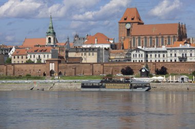 Torun, Poland - June 26, 2020: Panoramic view of Vistula River bank with monuments of Old Town. Gothic Torun Cathedral, Baroque Church of Holy Spirit