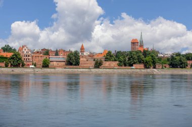 Torun, Poland - June 26, 2020: Panoramic view of Vistula River bank with monuments of Old Town. Church of Saint Jacob, church of Saint Catherine, Burgher House, former Evangelical Church of Holy Trinity