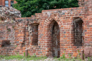 Torun, Poland - June 26, 2020: Ruins of gothic Teutonic Order 13th century Torun Castle. It was stronghold surrounded by defensive wall made of red brick