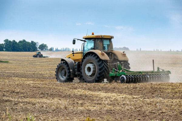 Tractor cultivating the field