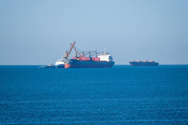 Bulk carrier is being loaded at sea